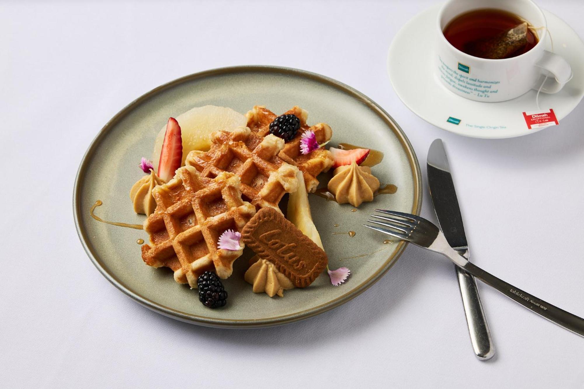 Stamford Plaza Melbourne Hotel Eksteriør billede The photo depicts a beautifully arranged plate of waffles. The waffles are topped with a variety of accompaniments including slices of fresh fruit, blackberries, and small dollops of cream or mousse. A decorative cookie is placed on the waffles, addi